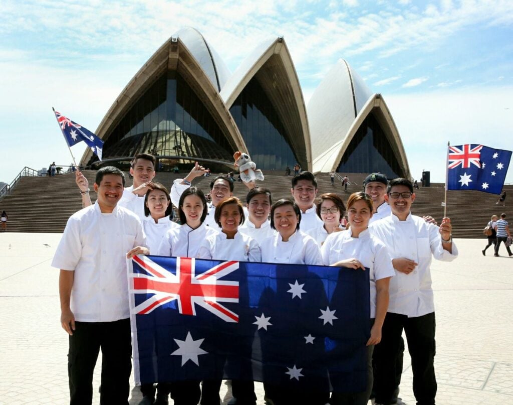 Chefs holding an Australian flag outside the Sydney Opera House